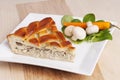Piece of pie with chicken and vegetable composition on dish