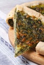 Piece of pie with green spinach and cheese close up vertical Royalty Free Stock Photo