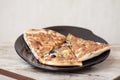Piece of pizza on black plate Royalty Free Stock Photo