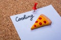 Piece of pizza Icon and cooking word on white paper