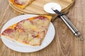 Piece of pizza with sausage, cutting board and cutter Royalty Free Stock Photo