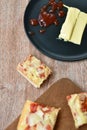 Piece of pizza topping sausage and cheese on cutting board Royalty Free Stock Photo