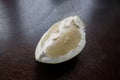 A piece of pomelo fruit on a dark kitchen table Royalty Free Stock Photo