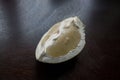 A piece of pomelo fruit on a dark kitchen table Royalty Free Stock Photo