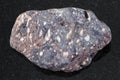 piece of porous basalt stone on dark background