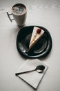 Piece of raspberry cheesecake dessert with coffee in a white cup on  table in a cafe Royalty Free Stock Photo