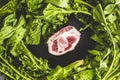Piece of raw ham on slate with turnip greens Royalty Free Stock Photo