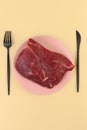 A piece of raw meat lies on a plate. Veal tenderloin. Predatory diet label. Zero carbohydrate diet concept. Ketogenic diet Royalty Free Stock Photo