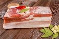 Piece of raw pork belly with garlic on wooden background Royalty Free Stock Photo