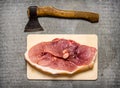 A piece of raw pork with a hatchet for meat cutting. Royalty Free Stock Photo