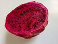 A piece of red dragon fruit on white background