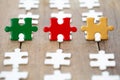 Piece of Red green and gold jigsaw puzzle On the old wood And green background. teamwork concept. symbol of association and Royalty Free Stock Photo