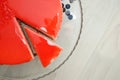 A Piece of Red Strawberry Cake covered with Mirror Red Glaze. Top View. Hole Cake with Copy Space. Wooden Table.