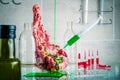 A piece of meat with a syringe with a green substance