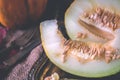A piece of ripe yellow melon lying on a rustic table. Royalty Free Stock Photo