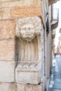 A piece of Roman sculpture on the corner of via valerio catullo and Corso Porta Borsari