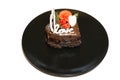 piece of romantic chocolate cake on black plate. Small baked cake decorated for Saint Valentines Day with love and heart mastic