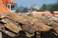 A piece of a rooftop with an old red tile pattern which is very
