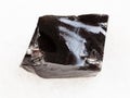 piece of rough Obsidian stone on white