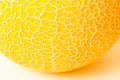 A piece of round yellow melon on a white surface. Texture. Royalty Free Stock Photo