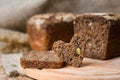 A piece of rye bread in the shape of a heart on the background of a fresh loaf. Royalty Free Stock Photo