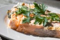 A piece of Salmon decorated with parsley leafs