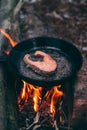 A piece of salmon in a pan over a fire. Cooking in nature. Grilled fish Royalty Free Stock Photo