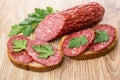 Piece of sausage and sandwiches with smoked sausage and parsley Royalty Free Stock Photo