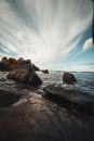 Piece of the shore of Lake Jatkonjarvi at sunset in Koli National Park, eastern Finland. View of the rocks surrounded by clear Royalty Free Stock Photo