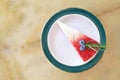 Piece of sliced red velvet cake in ceramic plate top view on marble table