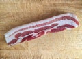 A piece of smoked pork bacon called tocino on a cutting board, ingredient of the typical fabada in Asturias, Spain Royalty Free Stock Photo