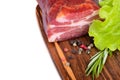 piece of smoked steak with spices on the board with salad and rosemary Royalty Free Stock Photo