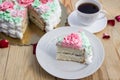 Piece of sponge cake with curd cream and banana on background of cake and cup of coffee. Royalty Free Stock Photo