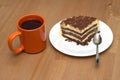 A piece of sponge cake on a plate and cup of tea close-up Royalty Free Stock Photo