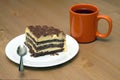 Piece of sponge cake on a plate and cup of tea close-up Royalty Free Stock Photo