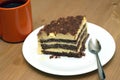 Piece of sponge cake on a plate and cup of tea close-up Royalty Free Stock Photo