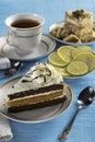 A piece of sponge cake on a white plate with a Cup of tea Royalty Free Stock Photo