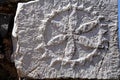 Piece of stone with sculptured symbol