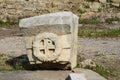 A piece of stone wall with a bas-relief of a Byzantine cross Royalty Free Stock Photo