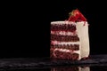 Piece of strawberry cake on a black background. Royalty Free Stock Photo