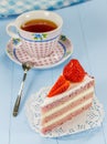 A piece of strawberry cake with a cup of tea Royalty Free Stock Photo