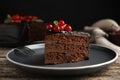 Piece of tasty homemade chocolate cake with berries and mint on wooden table, closeup Royalty Free Stock Photo