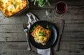 Piece of tasty hot lasagna with red wine. Small depth of field. Traditional italian lasagna. Portion. Italian food. Food on black Royalty Free Stock Photo