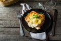 Piece of tasty hot lasagna with red wine. Small depth of field. Traditional italian lasagna. Portion. Italian food. Food on black Royalty Free Stock Photo