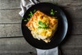 Piece of tasty hot lasagna with red wine. Small depth of field. Traditional italian lasagna. Portion. Italian food. Food on black Royalty Free Stock Photo