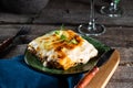 Piece of tasty hot lasagna with red wine. Small depth of field. Traditional italian lasagna. Portion. Italian food. Food