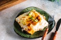 Piece of tasty hot lasagna with red wine. Small depth of field. Traditional italian lasagna. Portion. Italian food. Food Royalty Free Stock Photo