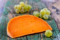 Piece of tasty mimolette cheese on white. Breakfast, chees. Royalty Free Stock Photo