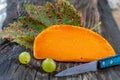 Piece of tasty mimolette cheese on white. Breakfast, chees. Royalty Free Stock Photo