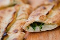 Piece of tasty Pide, turkish homemade pizza with cheese, spinach and herbs Royalty Free Stock Photo